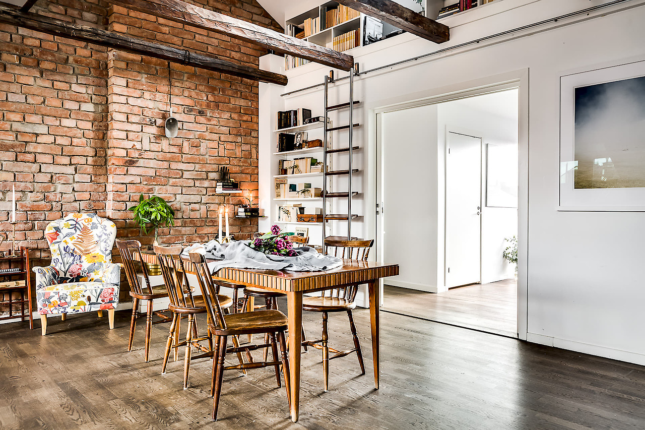 A gorgeous attic apartment with a brick wall